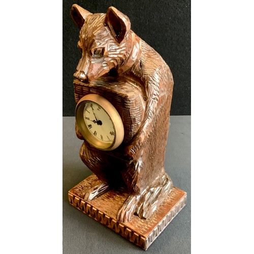 168 - A novelty black forest type timepiece carved as a bear, mechanical movement,  29cm high