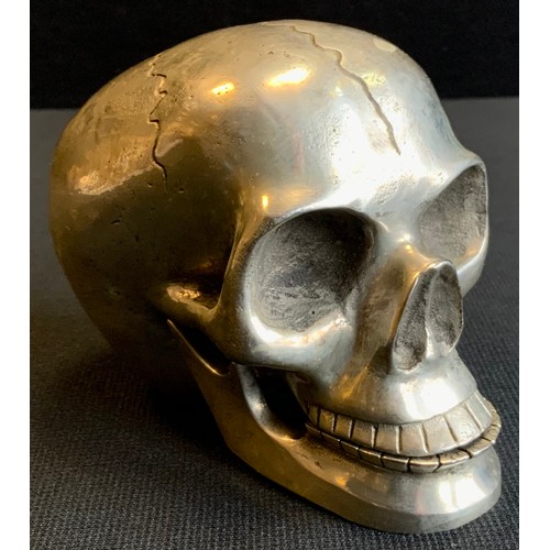 210 - A silver coloured metal skull, 10cm high