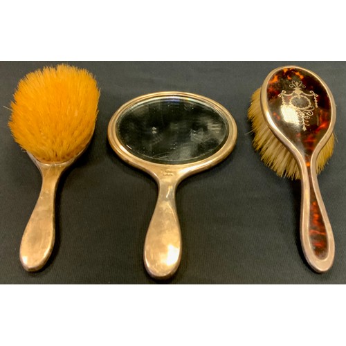 440 - A George V silver and faux tortoishell three piece dressing table set, hand mirror and pair of brush... 