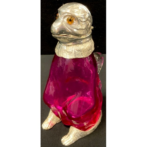 448 - A reproduction cranberry glass claret jug of a monkey sitting, mounted in silver plate