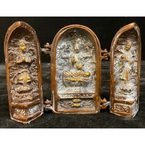 936 - Asian Art - a bronzed metal shrine or altar piece triptych, enclosing three figures, 14cm high