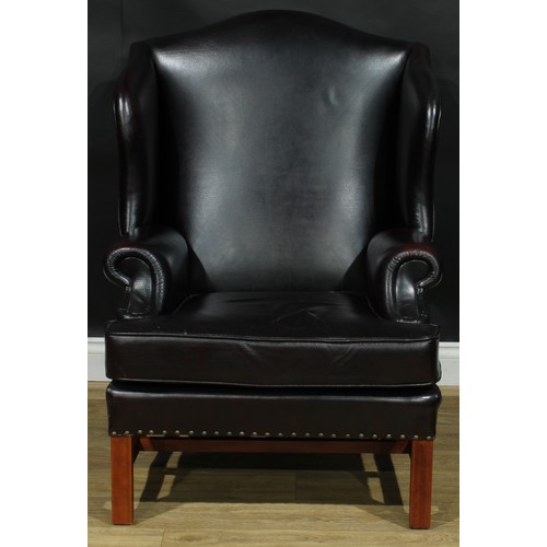 112 - A pair of contemporary George III style wing armchairs, by Parker Knoll, stuffed-over aubergine leat... 