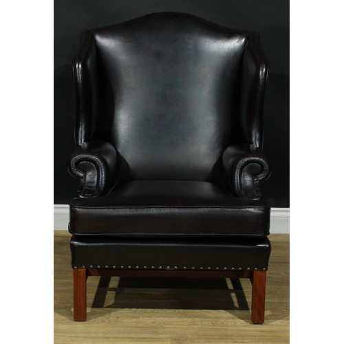 112 - A pair of contemporary George III style wing armchairs, by Parker Knoll, stuffed-over aubergine leat... 