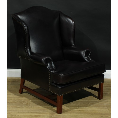 112 - A pair of contemporary George III style wing armchairs, by Parker Knoll, stuffed-over aubergine leat... 