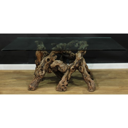 120 - A rootwood table base, glass top, 74.5cm high, 180.5cm long, 107cm wide