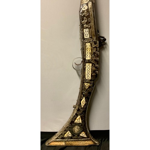 1300 - An Afghan flintlock jezail, silver coloured metal and bone mounted, 134cm long