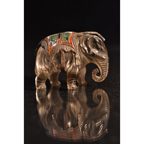 164A - A carved rock crystal enamel and metal elephant, carved standing with ornate cast and enamelled base... 