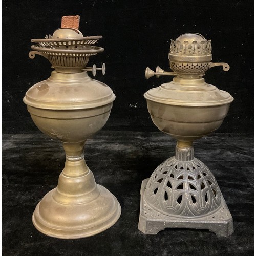 1450 - An early 20th century brass oil lamp; another, with cast iron base (2)