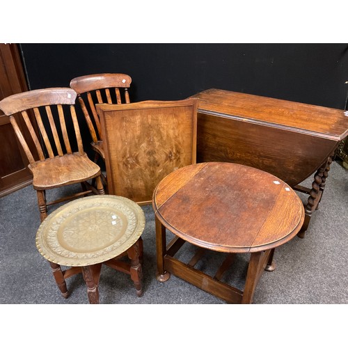 55 - An metamorphic oak armchair / side-table, c.1950, 80cm high x 71cm wide x 57cm (as a chair);  a pair... 