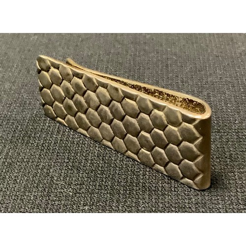 379 - Tiffany & Co - A silver coloured metal money clip, cast with honeycomb, plain to verso, stamped ster... 