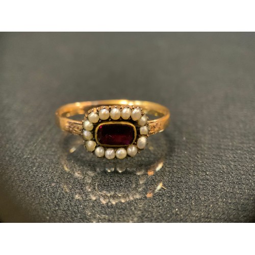 441 - A 19th century garnet and seed pearl mourning ring, unmarked yellow metal shank, size T, 3.7g gross