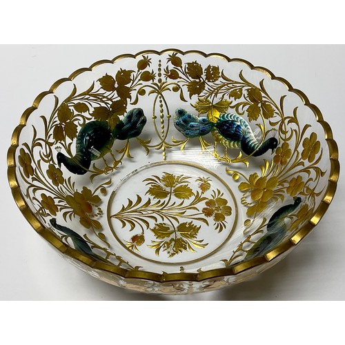 32 - A late 19th century Bohemian glass bowl, engraved with peacocks and scrolling foliage, picked out in... 