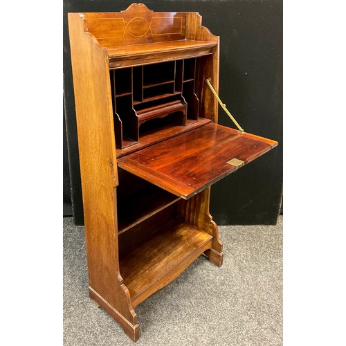 38 - An Edwardian mahogany student’s bureau, three-quarter galleried top, above a fall door enclosing fit... 