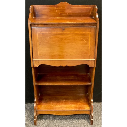 38 - An Edwardian mahogany student’s bureau, three-quarter galleried top, above a fall door enclosing fit... 