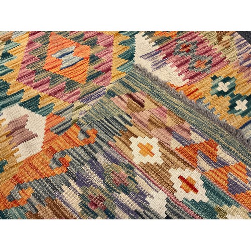 41 - A Turkish Anatolian Kilim runner carpet / rug, knotted in bright tones of red, jade green, yellow, a... 