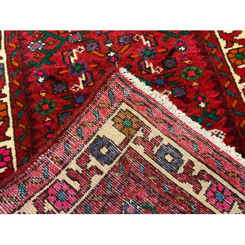 62 - A North west Persian Malayer runner carpet, hand-knotted in red, deep blue, turquoise, and green, 29... 