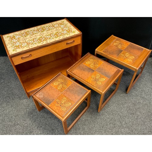 216 - A G-plan nest of three teak, tile-top tables, the largest table measuring 50cm high x 59cm wide x 46... 