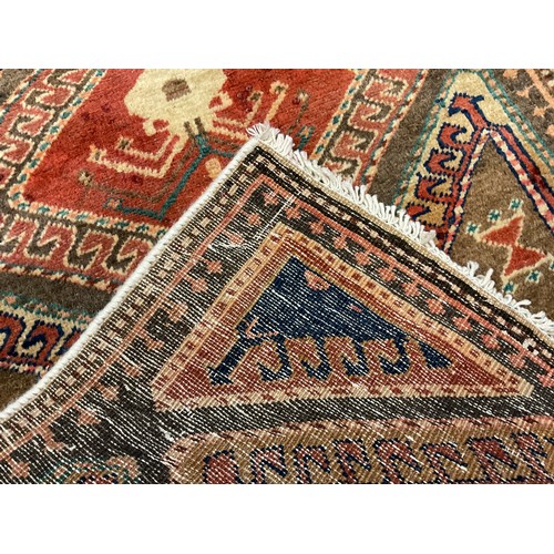 218 - A North west Persian Heriz runner carpet, hand-knotted in earthy tones, with accents of green and bl... 