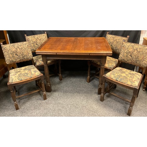 221 - An oak draw-leaf table and four chairs