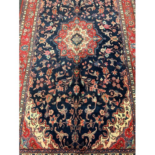 254 - A central Persian Sarouk carpet, hand-knotted with a central lotus form medallion, within a stylised... 