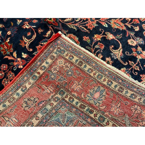 254 - A central Persian Sarouk carpet, hand-knotted with a central lotus form medallion, within a stylised... 