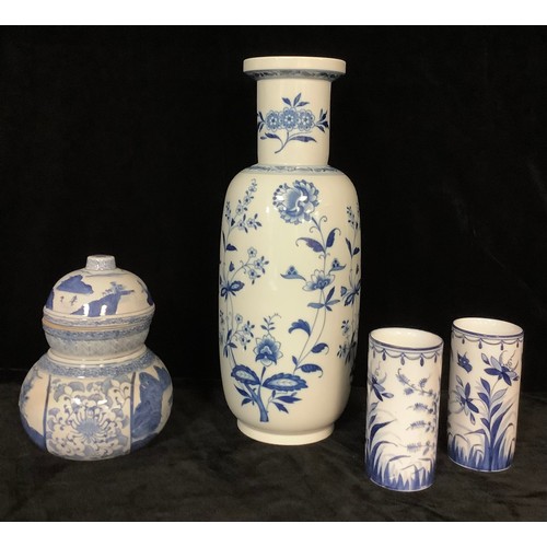 3 - A Chinese export ware blue and white gourd shaped vase and cover, painted with mountain and lake lan... 