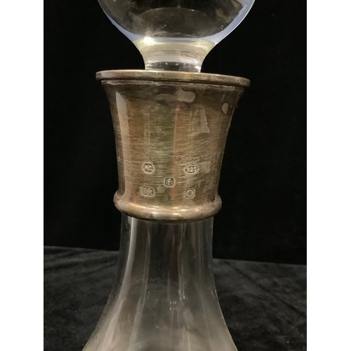 27 - A clear glass decanter and stopper, silver collar, Sheffield 2005, 30cm; a conical clear glass decan... 