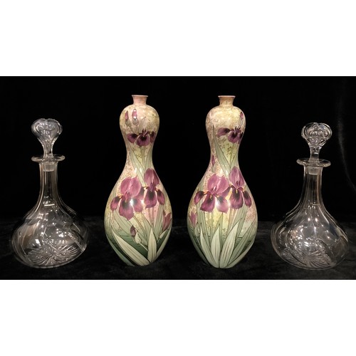 39 - A pair of gourd shaped vases by Thomas Forester and Sons, England, decorated with flag irises; a pai... 