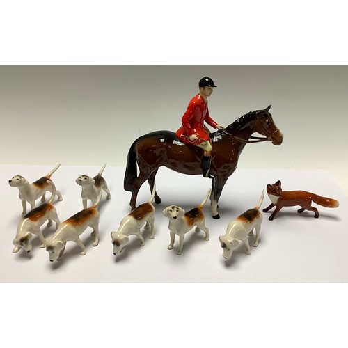 170 - A Beswick hunting group comprising huntsman on horseback, seven hounds, fox