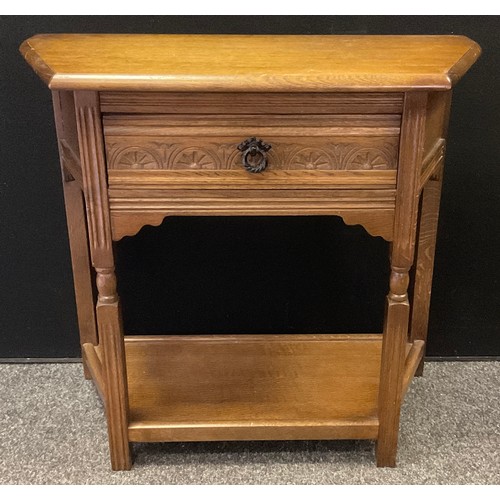 27 - An Old Charm style oak hall table, canted rectangular top, single drawer to frieze, shelf to base, 7... 