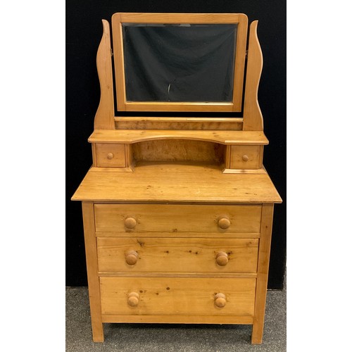 51 - A Pine dressing chest, bevelled rectangular mirror, with pair of small drawers, above three graduate... 