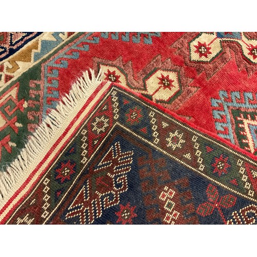 83 - A Turkish Bergama style woollen rug / carpet, knotted in shades of red, turquoise, deep blue, and gr... 