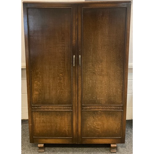 93 - A mid 20th century Oak double wardrobe, 182cm high x 117cm wide x 48.5cm.