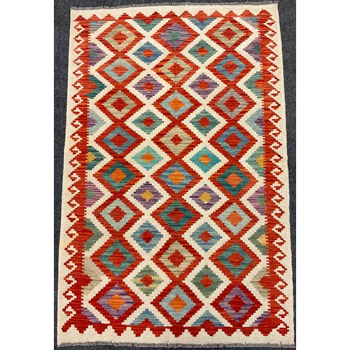 392 - A Turkish Anatolian Kilim rug / carpet, knotted in vibrant tones of red, jade green, orange, and blu... 