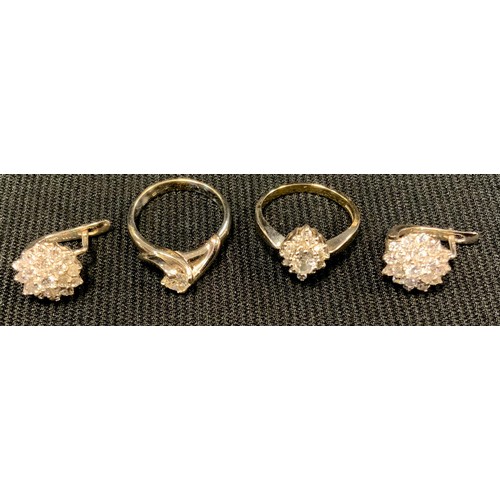 499 - A white metal dress ring and earring suite, shank and pillars stamped 750, 8.2g gross;  another soli... 