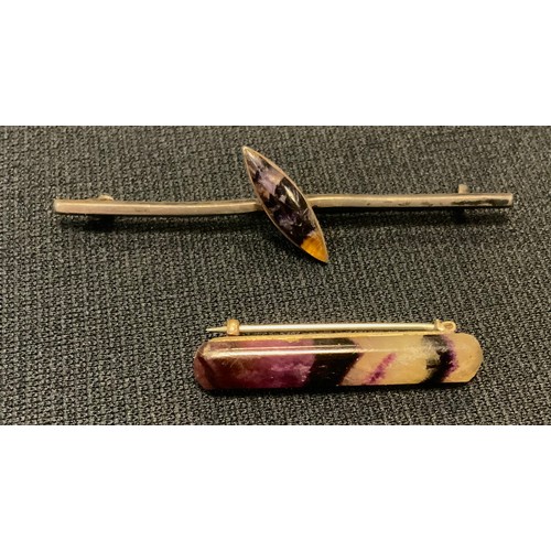 507 - A blue john baton bar brooch, 3.5cm long, unmarked silver coloured metal mount;  another navette (2)