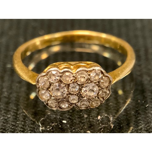 509 - A diamond ring, double flowerhead shaped crest pave set with sixteen round brilliant cut diamonds, t... 