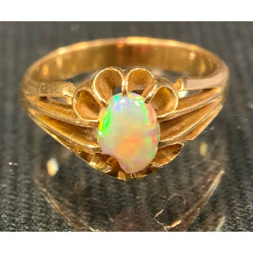 512 - A early 20th century opal ring, oval cabochon opal, approx 0.30ct, unmarked yellow metal shank, size... 