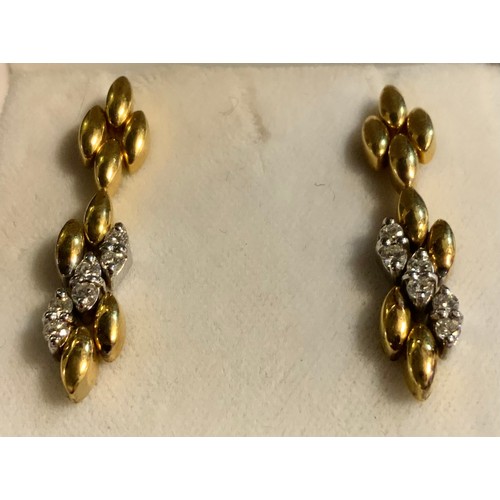 518 - A pair of diamond set white and yellow gold articulated drop earrings, each set with six round brill... 