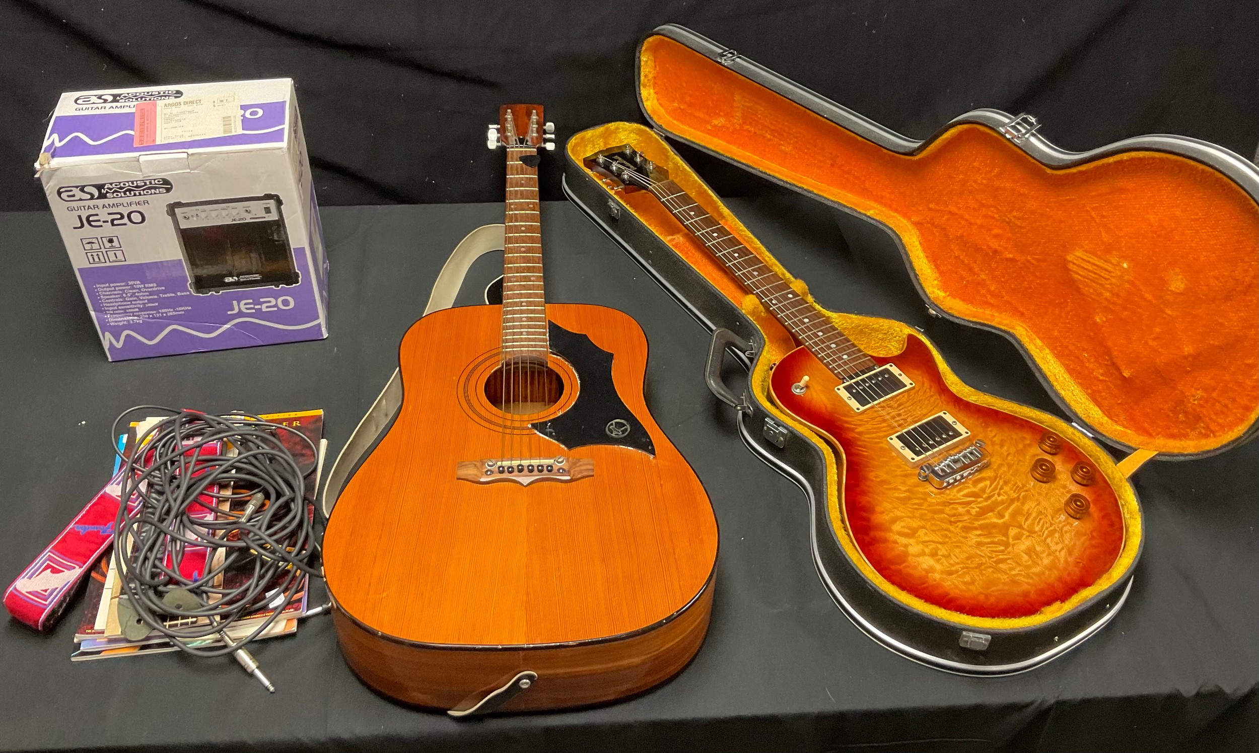 A Gordon Smith guitar, cased; guitar strap, guitar leads, a JE20 Amp