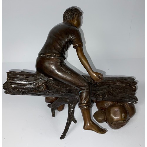 46 - A reproduction bronzed figure, bare foot boy sat astride a log trout tickling, 24cm high