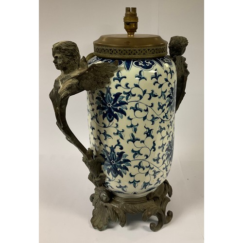 60 - A large bronzed metal mounted table lamp, painted in the Chinese taste in underglaze blue with flowe... 