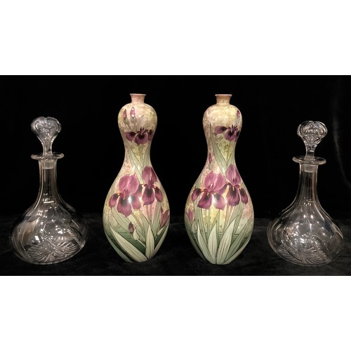 65 - A pair of gourd shaped vases by Thomas Forester and Sons, England, decorated with flag irises, 31.5c... 