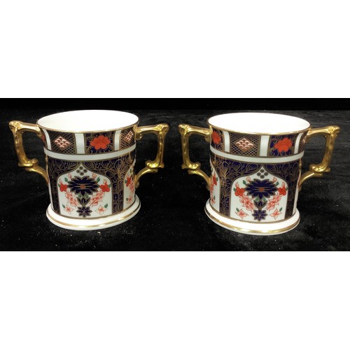 73 - A pair of Royal Crown Derby Imari 1128 pattern two handled loving cups, first quality, 7.5cm diamete... 