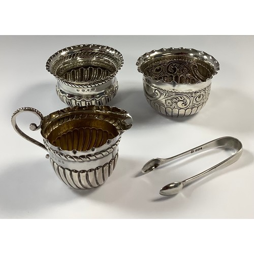 96 - A Victorian silver stop fluted cream jug, 6.5cm, Birmingham 1888, 43g; two silver sugar bowls, a pai... 