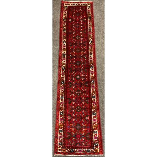 71 - A North west Persian Malayer runner carpet, hand-knotted in red, deep blue, turquoise, and green, 29... 