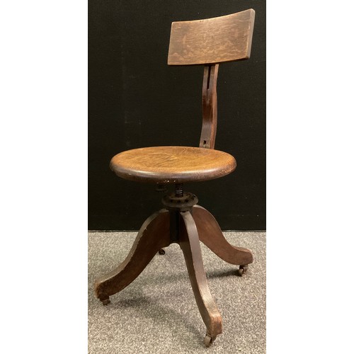 77 - A Late Victorian/Edwardian Kendrick and Jefferson oak desk chair, revolving seat, cast iron body pat... 