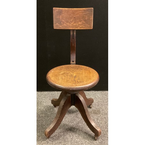 77 - A Late Victorian/Edwardian Kendrick and Jefferson oak desk chair, revolving seat, cast iron body pat... 