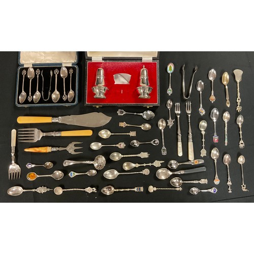 174 - A set of EPNS teaspoons, pierced terminals, boxed; a salt and pepper pot, boxed; pickle forks, mothe... 