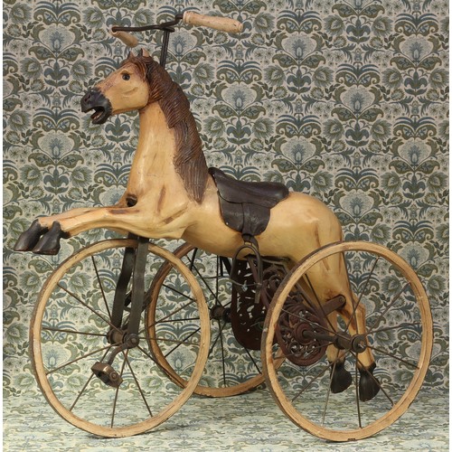 6056 - A 'Victorian' style carved wooden and painted child's velocipede tricycle, in the form of a gallopin... 